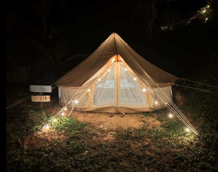 Illuminated glamping tent at night in a tropical setting in Koh Tao, Thailand